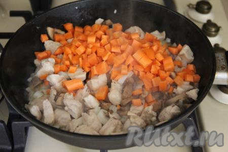Когда лук обжарится до полупрозрачности, добавить в сковороду морковку, нарезанную на мелкие кубики (или натёртую на крупной тёрке), перемешать, обжаривать овощи с мясом и грибами, периодически перемешивая, 4-5 минут (морковка должна стать достаточно мягкой).